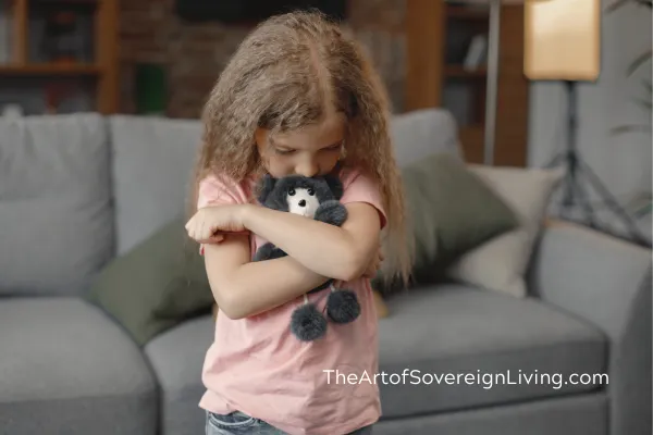A Child Upset Holding a Teddy Bear