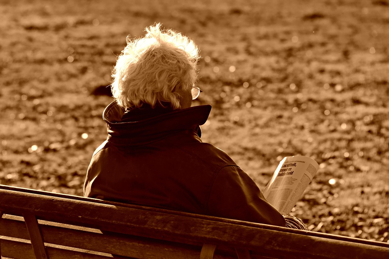 An adult child helps their elderly parent down a porch step, showing the care and concern involved in deciding when it’s time for a safer living environment.