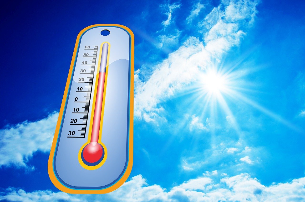 A close-up of a thermometer showing dangerously high temperatures, representing the extreme summer heat risks facing seniors in the DFW area.