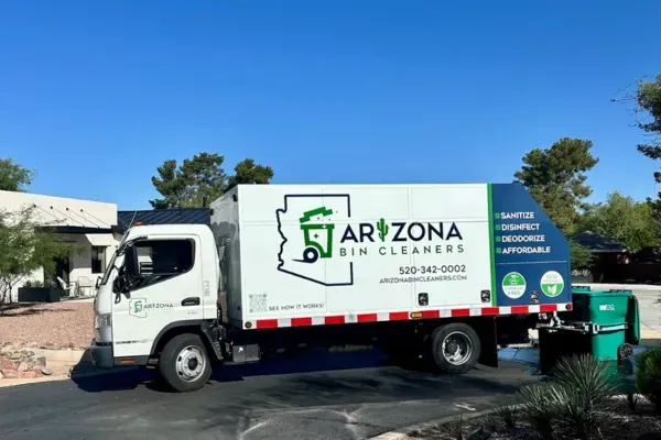 Arizona Bin Cleaners sanitation truck cleaning residential garbage bins on a sunny day in Arizona.