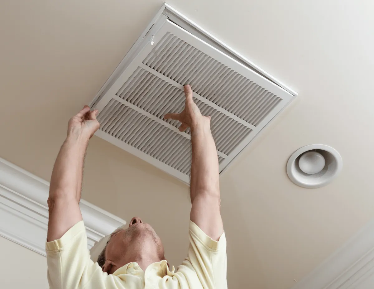 A man changing an air filter