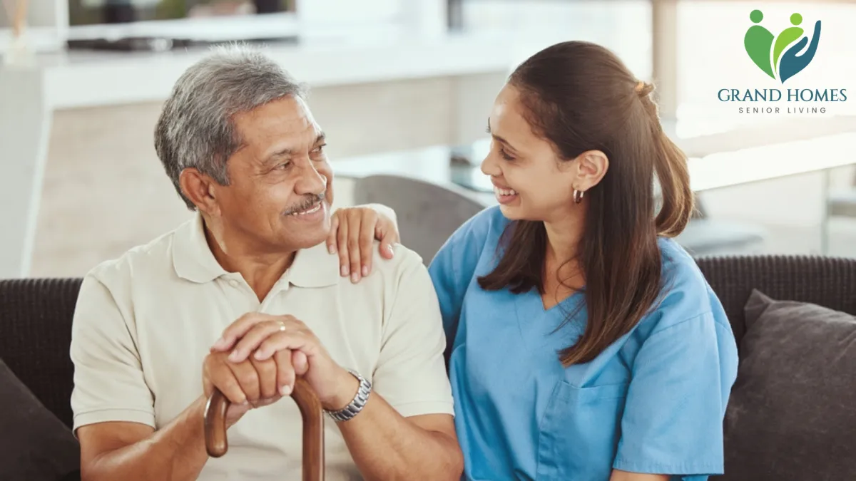 Elderly man receiving personal care support from a smiling caregiver at home