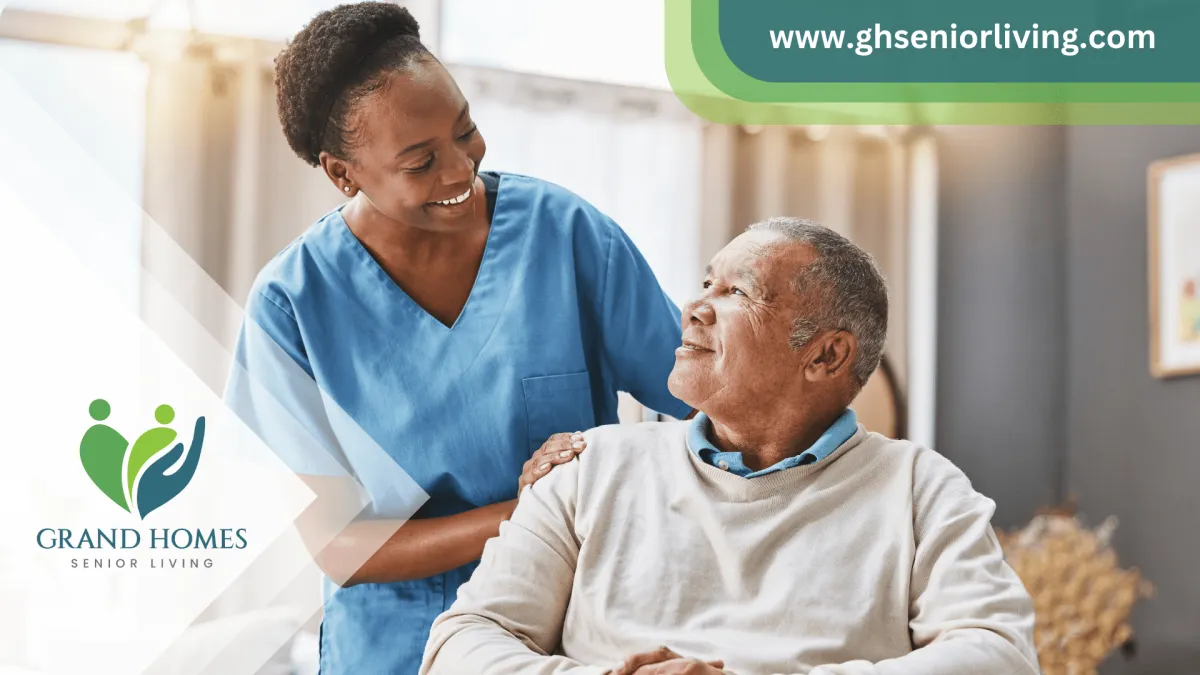 Female caregiver smiling and talking to a senior man in a wheelchair at an assisted living facility.