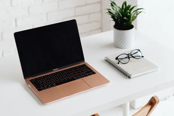 desk with a notebook and glasses