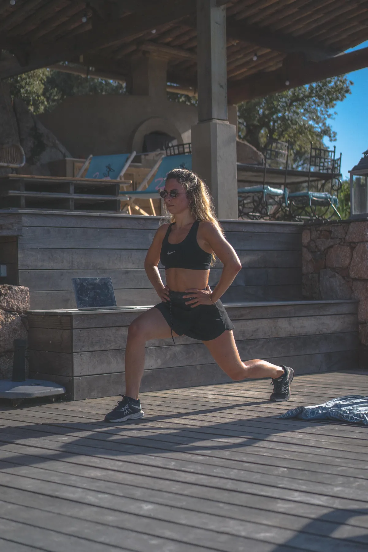 Fit woman performing pelvic floor exercises by doing lunges, highlighting the importance of taking care of one's pelvic floor for overall health and well-being.