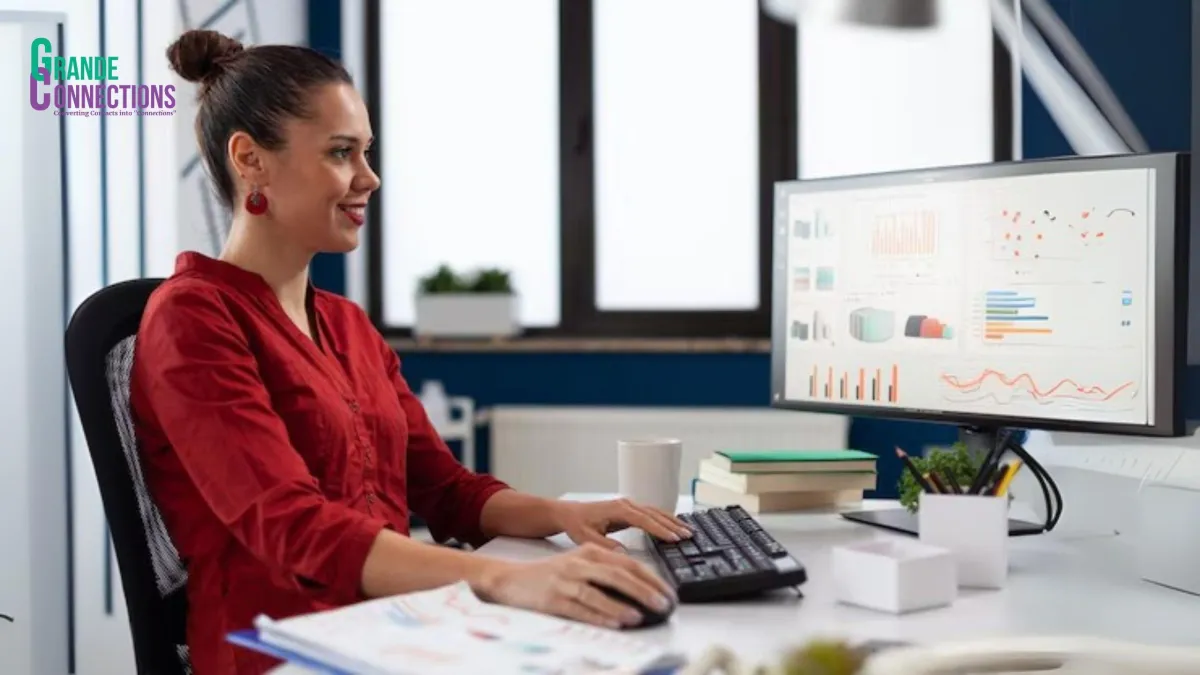 Entrepreneur smiling while reviewing sales growth charts and gratitude cards.