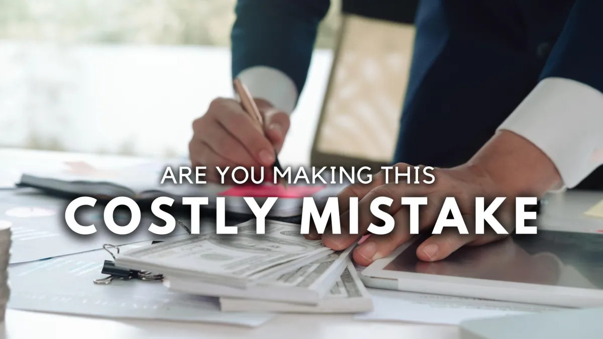 Frustrated entrepreneur sitting at cluttered desk, symbolizing costly client retention mistakes.