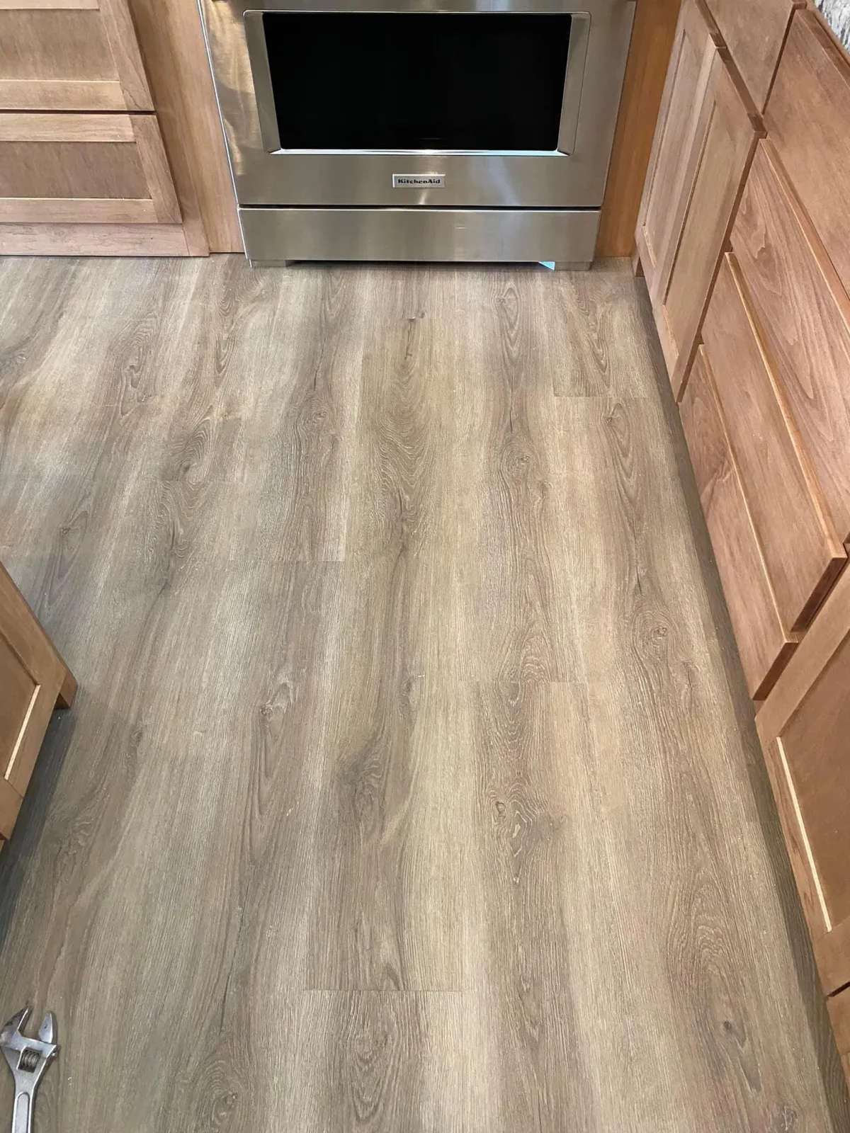 "Open-concept kitchen with dark slate tile flooring, high-end appliances, and sleek quartz countertops."