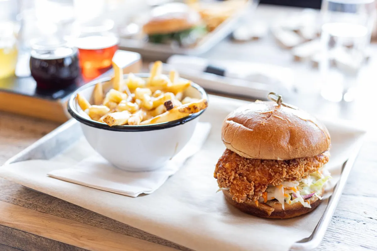 Crunchy chicken sandwich and bowl of fries at Folding Mountain Brewing