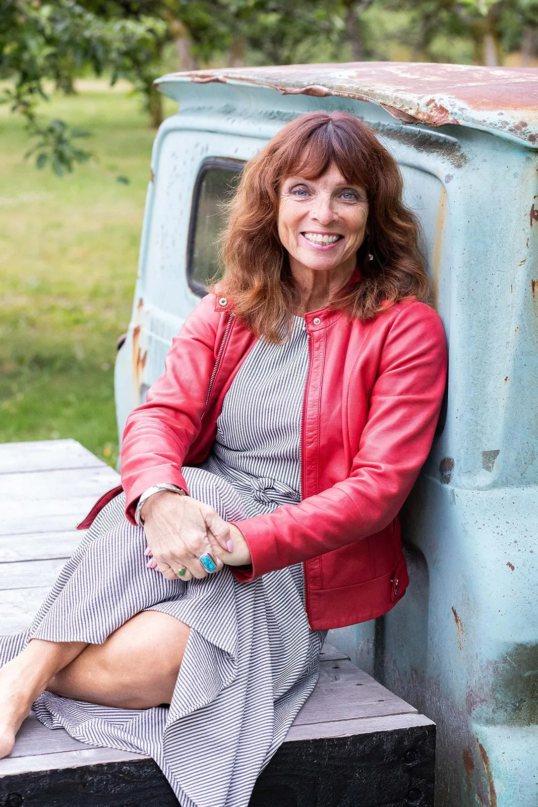 Janet Docherty, owner of Merridale Cidery & Distillery, sitting on their iconic vintage truck