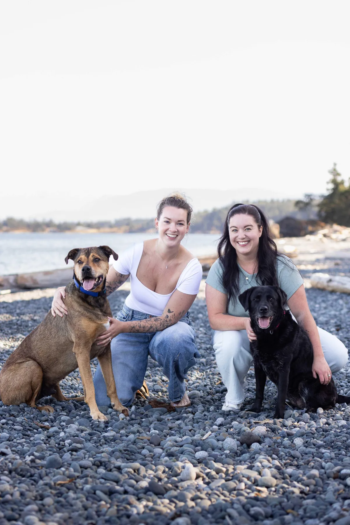 Sisters with dogs on Taylor Beach in Metchosin BC