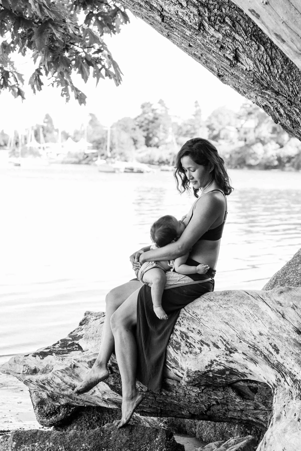 Mama feeding baby on beach