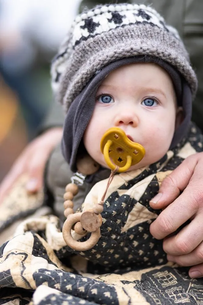 Baby wrapped up in layers looking at camera