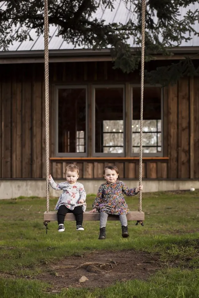 Cousins sitting on swing at Bilston Creek Farm