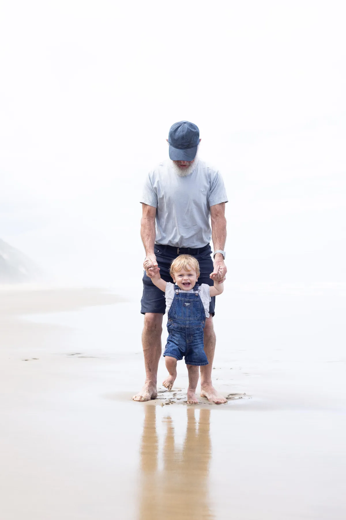 Grandfather and grandson on Bayley's Beach New Zealand
