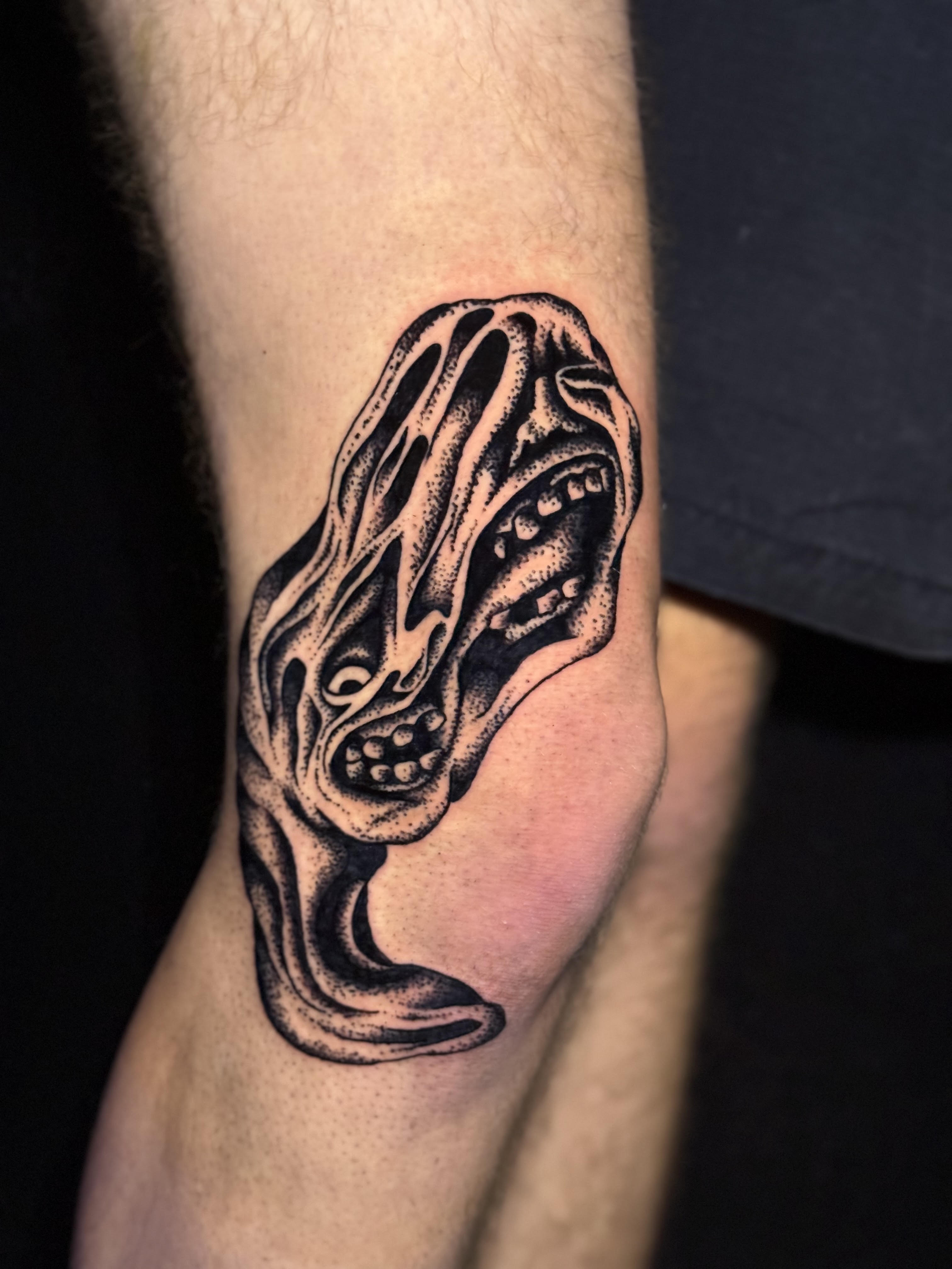 Photo of client's leg with stippling horror tattoo by Aiden at Red Arbor Tattoo