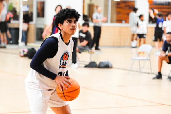 High school boy shooting a basketball at a basketball training camp