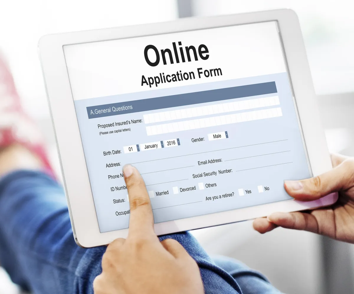 Person filling out job application online.