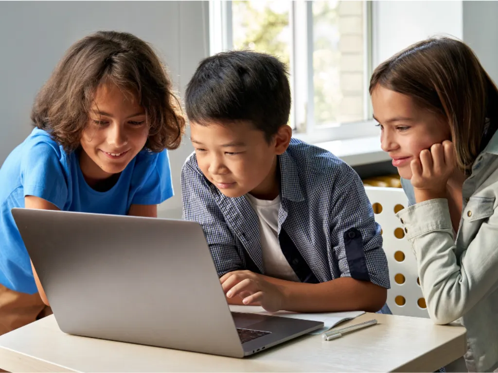 children circled around a computer
