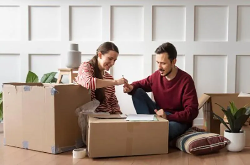 Family in a Dallas home preparing to move out of state while viewing a virtual home showing online.