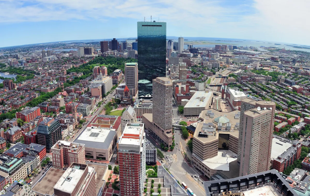 Aerial view of Downtown Dallas skyline leading into suburban neighborhoods