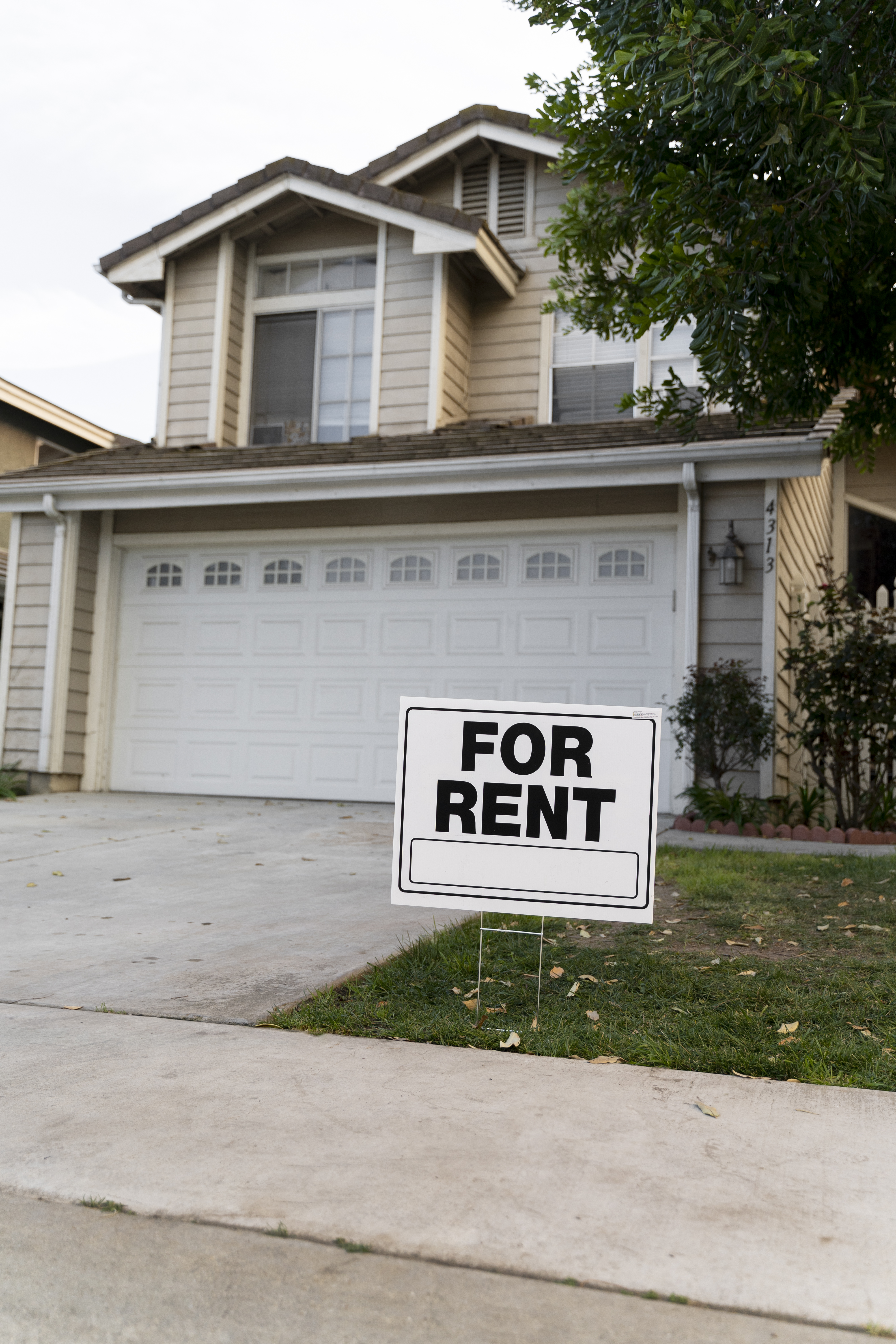 A “Sold” sign in front of a Dallas home with a new-construction neighborhood in the background.