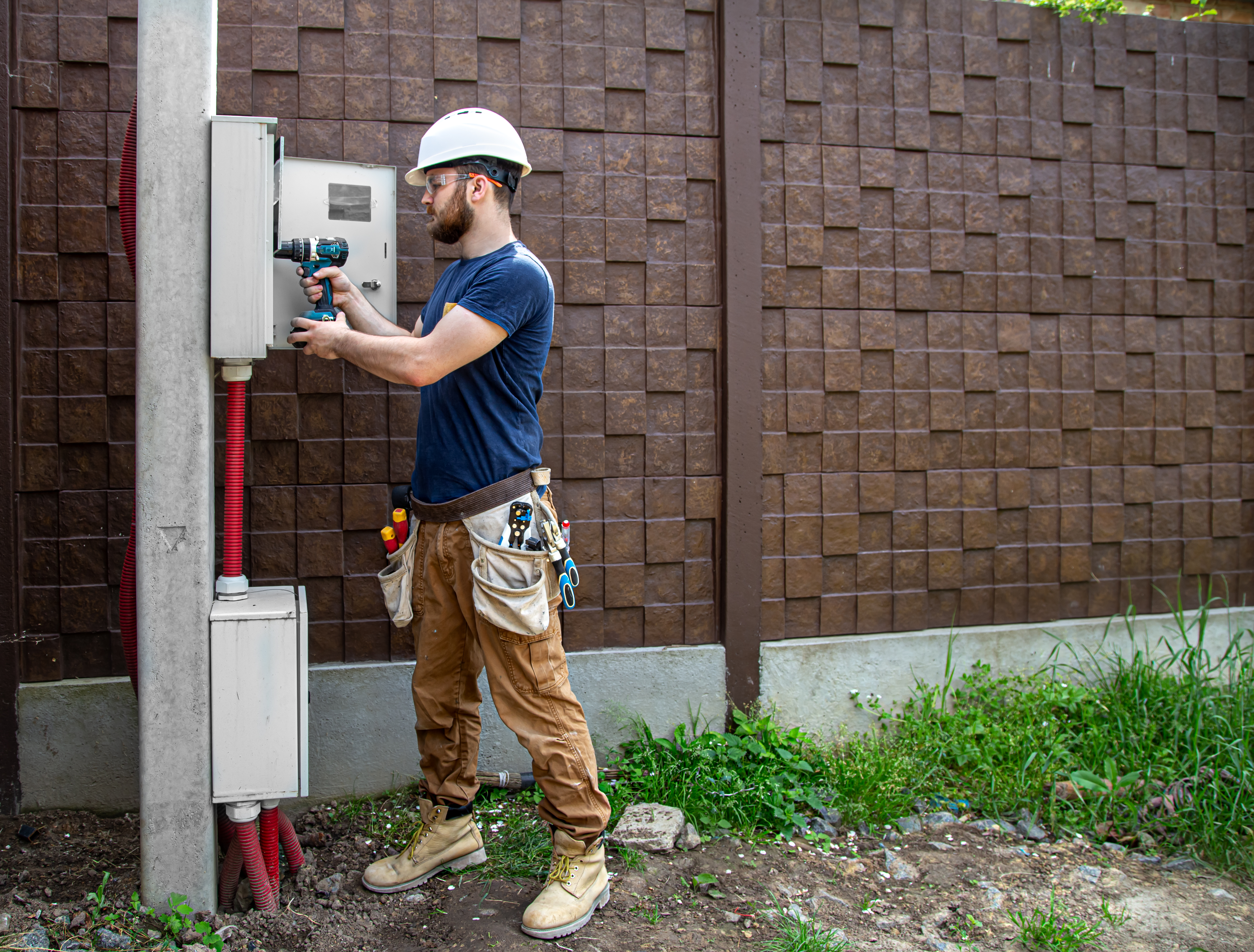 A professional home inspector examining the electrical panel of a North Texas home before it is listed for sale.