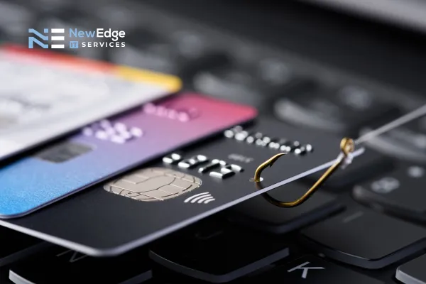 phishing hook on credit card on top of a keyboard
