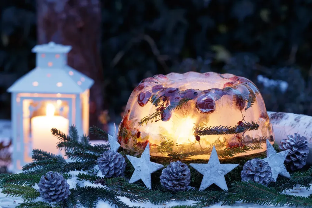 An ice lantern sits on a table with a candle inside