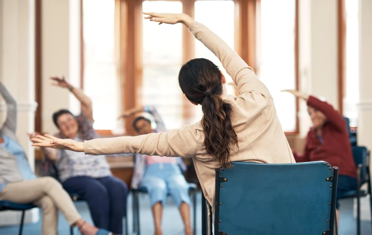 Physical therapy session with patients exercising together in a clinic offering coordinated multidisciplinary care.