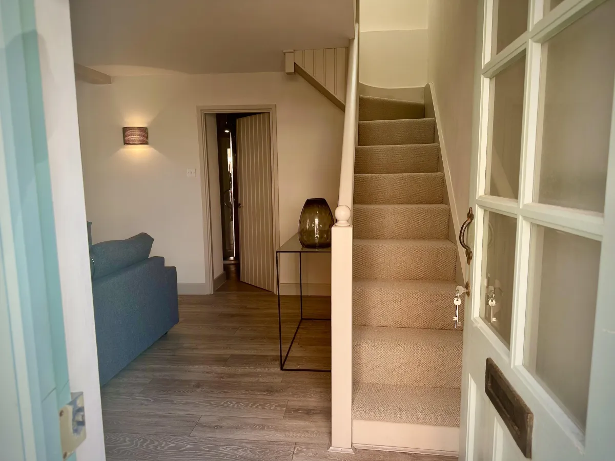 StayatNo12 - entrance door to sitting room showing shower room and staircase