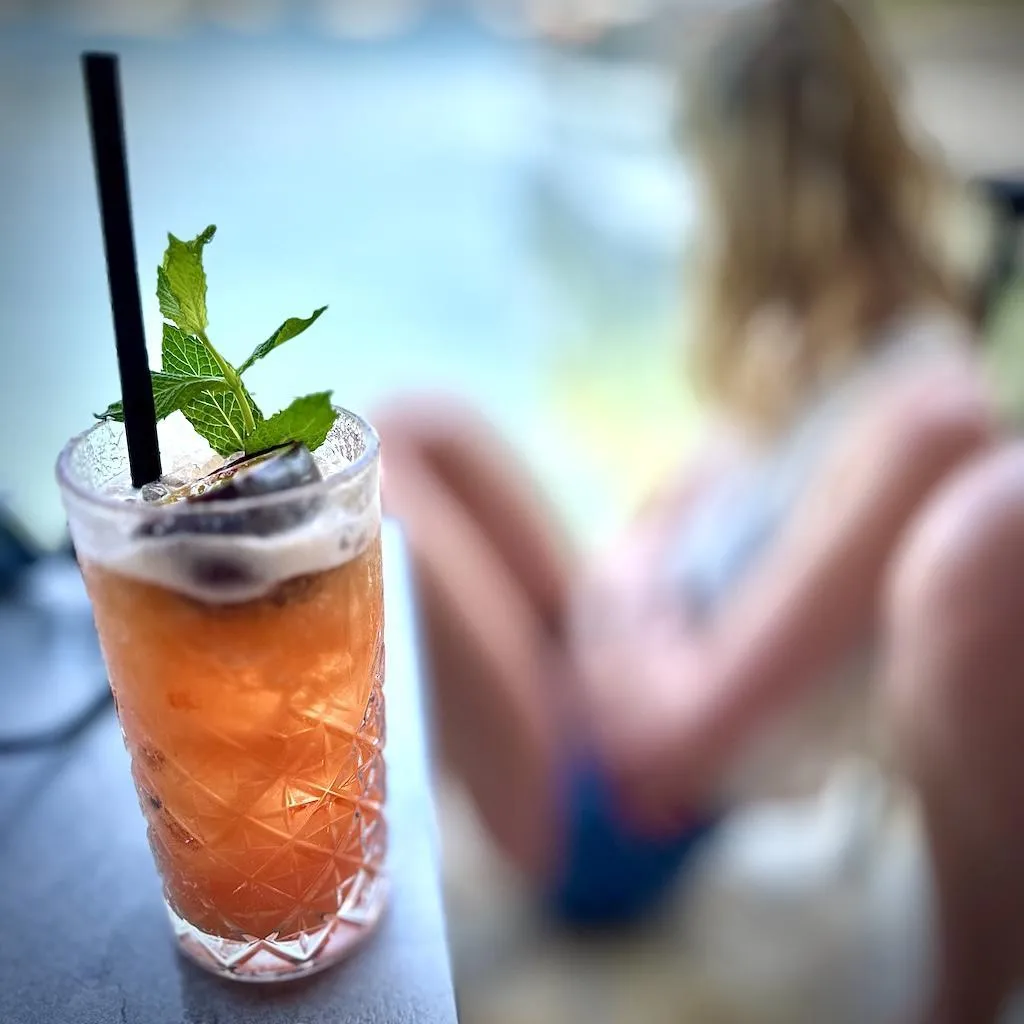 A refreshing cocktail drink served outdoors with views of the Jurassic Coast