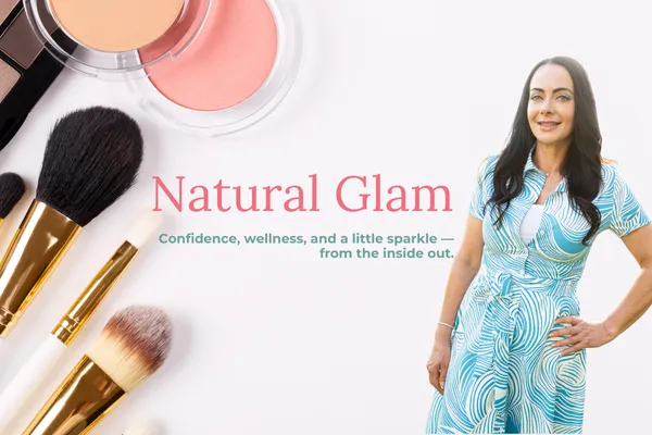 Jen Sells standing in a teal patterned dress with natural makeup, smiling confidently beside makeup brushes and blush powders, representing her Natural Glam blog theme focused on wellness, confidence, and sparkle.