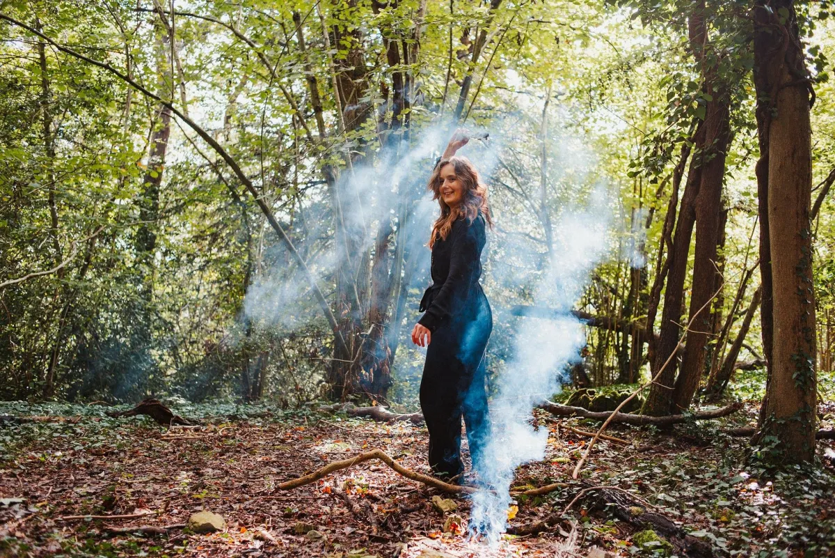Woman dancing in the woods.