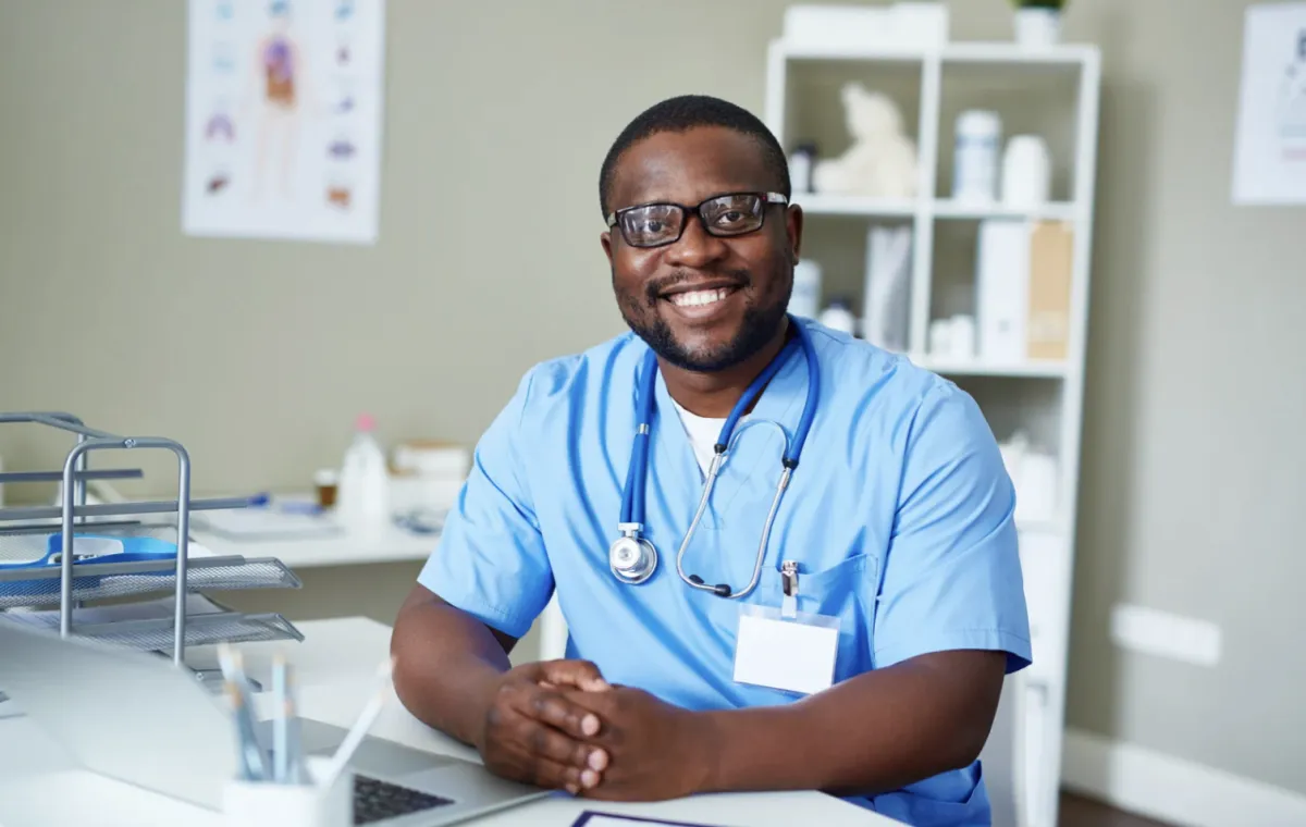 Doctor Smiling At Desk