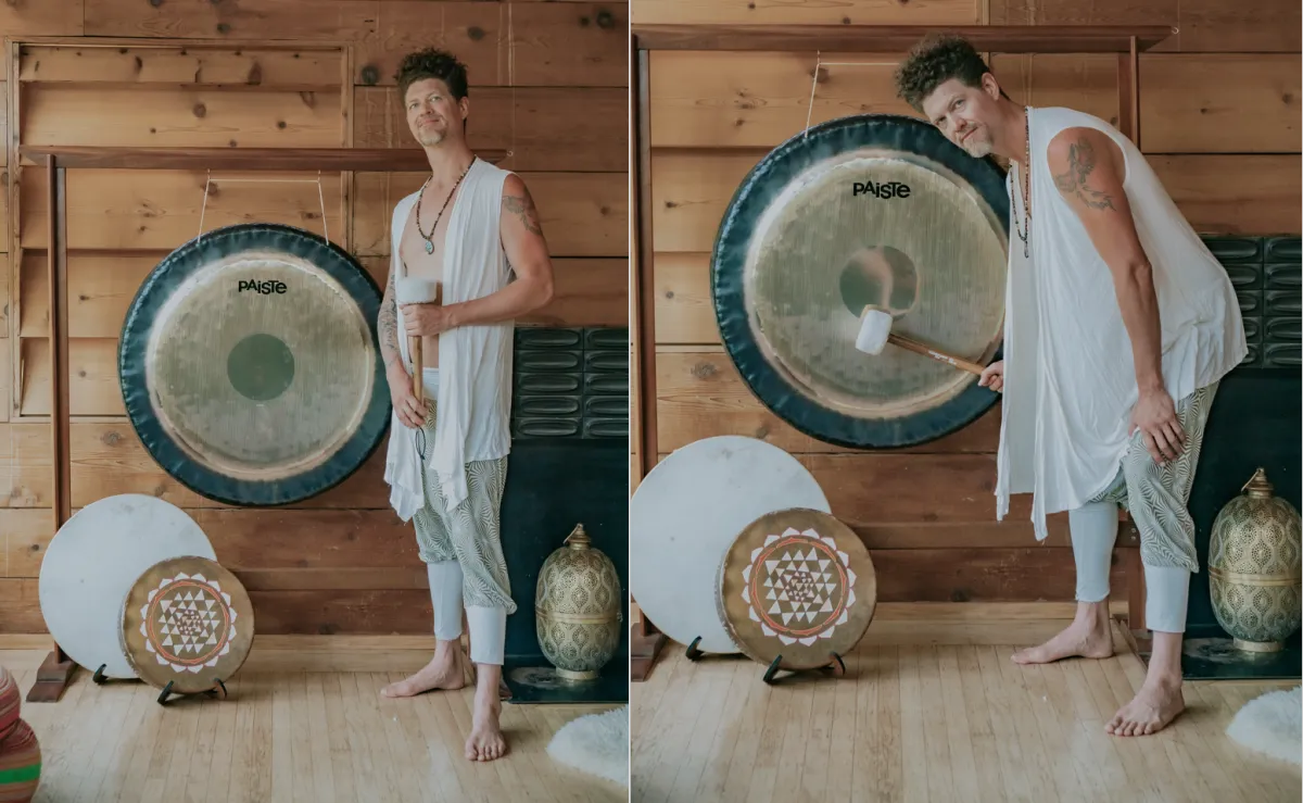 Man meditating in front of a gong with ceremonial drum and mallet during a sound healing session