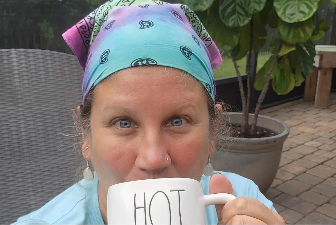 Stacy sips from a mug