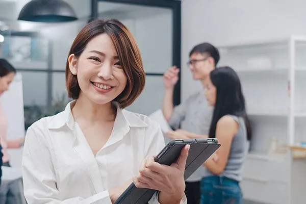 HR manager smiling confidently, symbolizing empowerment and readiness for 2025