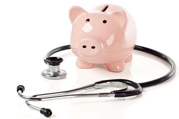 Stethoscope around a pink piggy bank, symbolizing tracking and measuring health ROI for workforce well-being