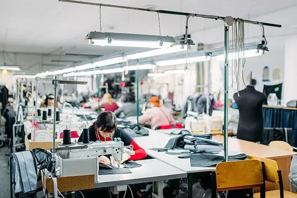 Workers sewing in a textile production area