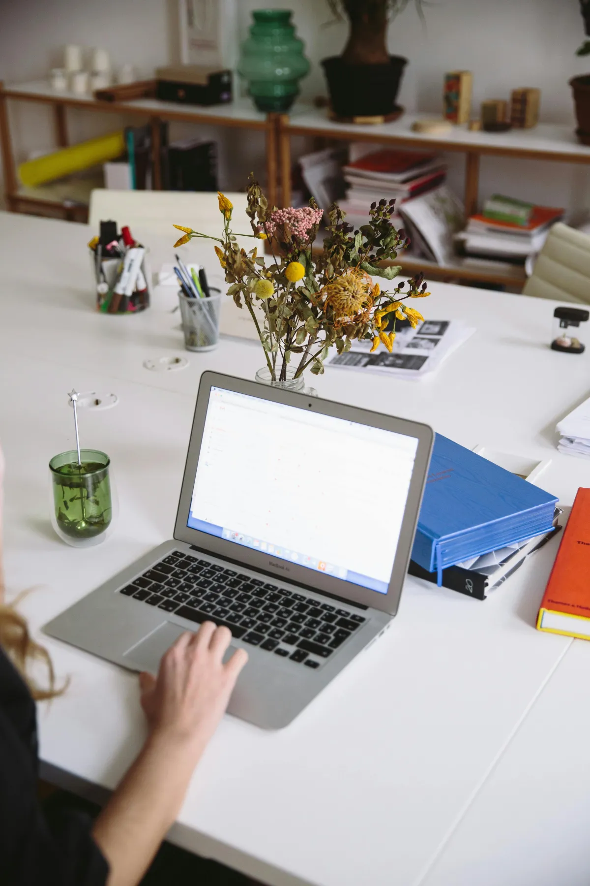 Image of author anchor va at a computer hard at work.