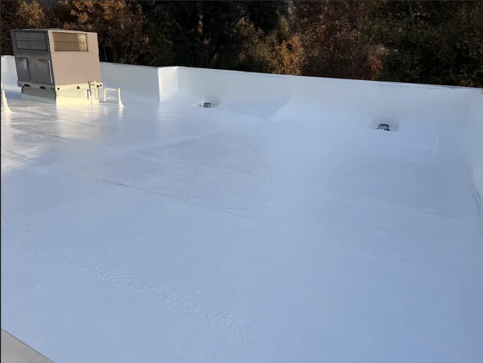 Roof with freshly applied reflective coating by Pioneer Roofing in Bakersfield, CA