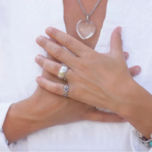 women holding her hands over her chest/heart meditating