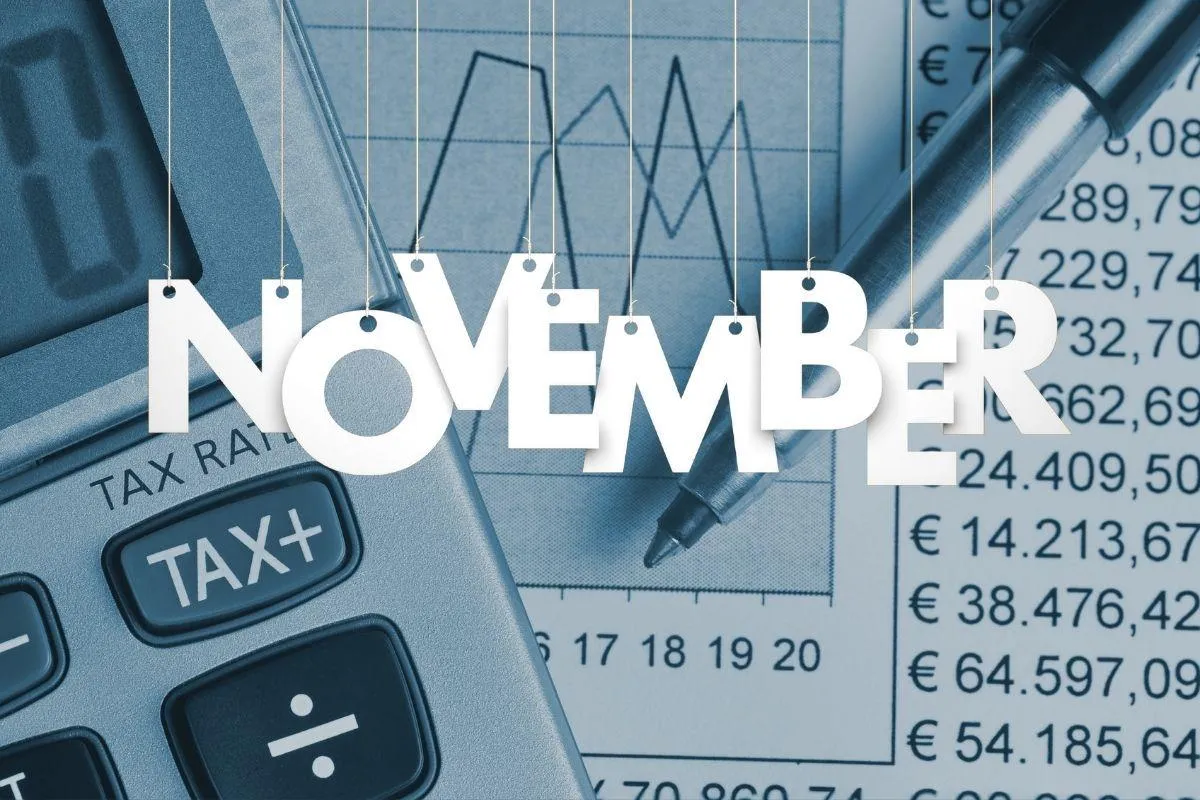 November and tax documents and calculator on table