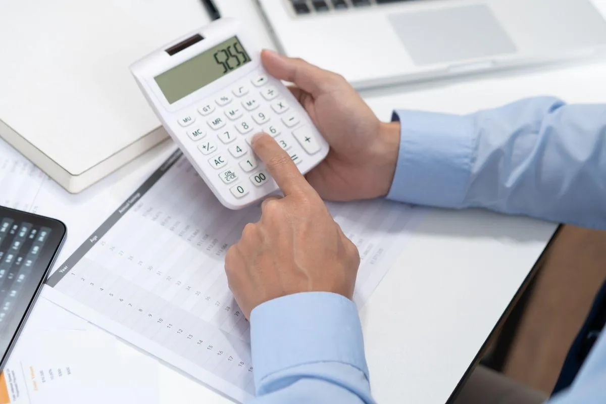 Bookkeeper adding vendor charge on calculator