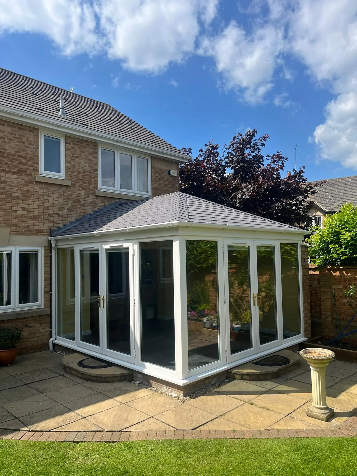 A bright and airy Edwardian-style conservatory with a fully insulated tiled roof, designed to improve energy efficiency and comfort in all seasons.