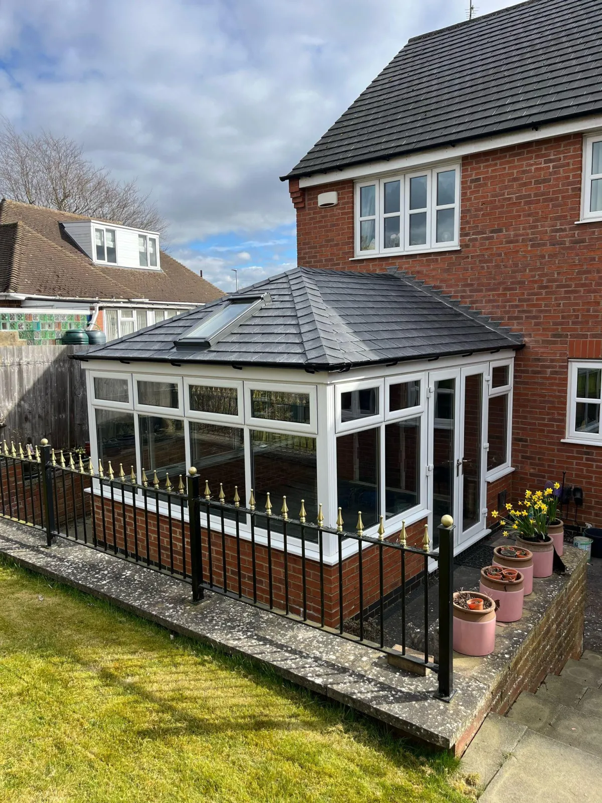 A newly transformed conservatory featuring a sleek, energy-efficient tiled roof with a Velux window for added natural light and ventilation.