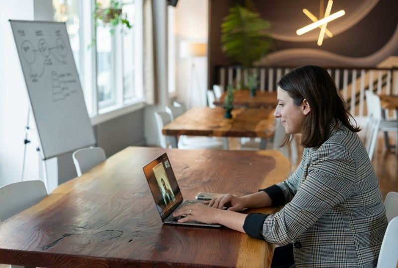 Businesswoman attending a virtual meeting on her laptop.