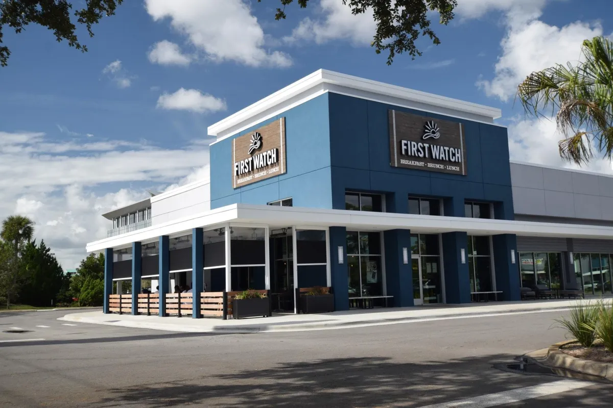 A serene patio featuring a stylish pergola and comfortable lounge chairs for relaxation and outdoor enjoyment.