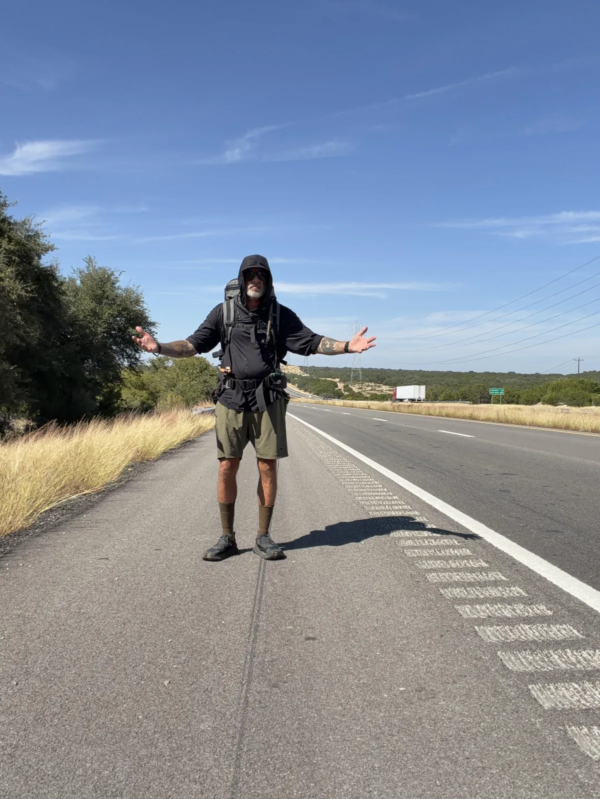 man standing on highway - official project grit